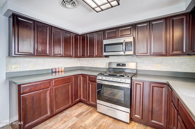 kitchen featuring appliances with stainless steel finishes and light wood-type flooring