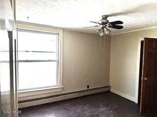 400 N Vance St, Carey, OH 43316 - empty room featuring a baseboard radiator and baseboards