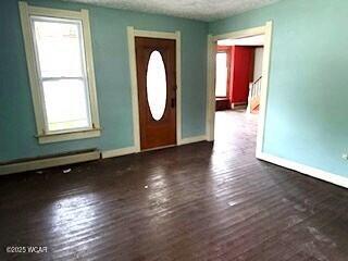 400 N Vance St, Carey, OH 43316 - entryway featuring hardwood / wood-style flooring, a baseboard heating unit, and a textured ceiling