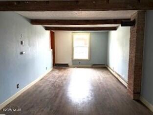 400 N Vance St, Carey, OH 43316 - below grade area with baseboards and wood finished floors