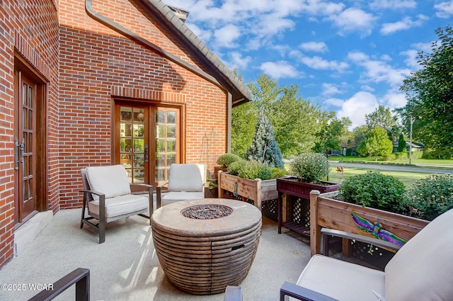 view of patio / terrace with french doors and a fire pit