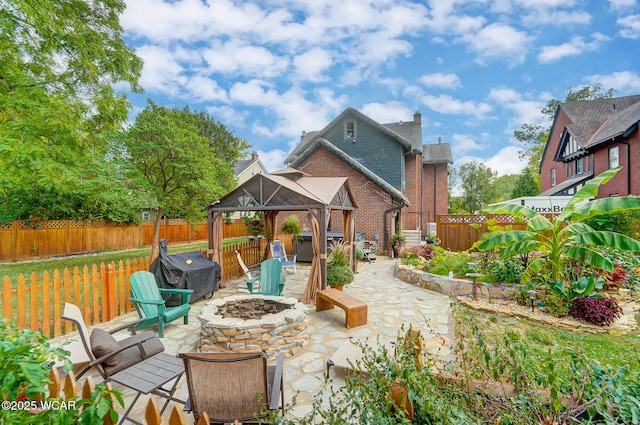 view of patio / terrace featuring a gazebo, grilling area, a jacuzzi, and a fire pit