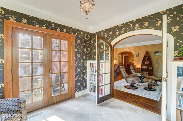 interior space with french doors and ornamental molding