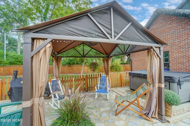 view of patio / terrace with a gazebo and a hot tub