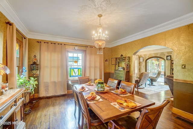 dining room with a notable chandelier, ornamental molding, dark hardwood / wood-style floors, and a healthy amount of sunlight