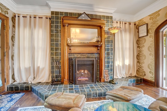 sitting room featuring crown molding, dark wood-type flooring, and a fireplace