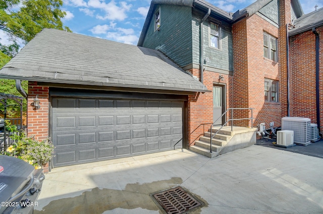 view of front of home with cooling unit and a garage