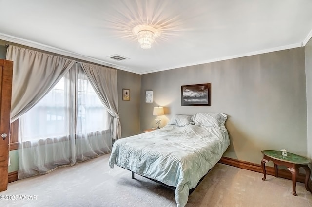 bedroom with ornamental molding and carpet