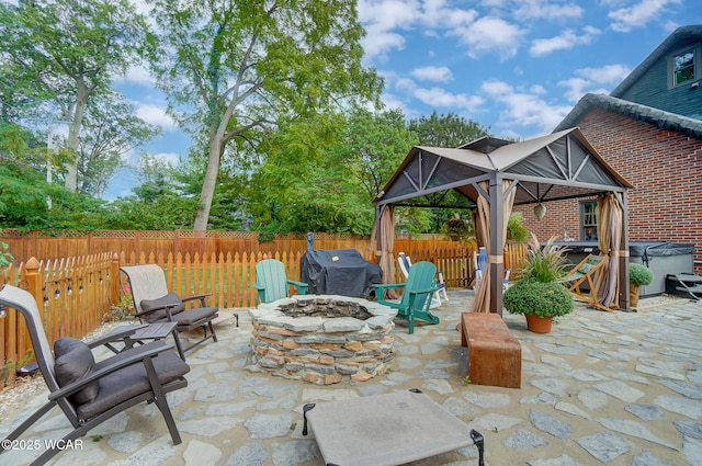 view of patio / terrace featuring a gazebo and a fire pit