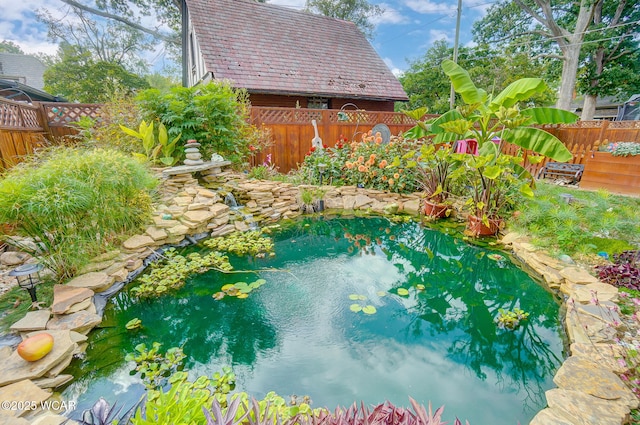 view of pool with a garden pond