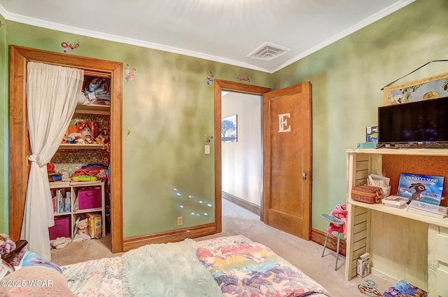 bedroom featuring a closet, ornamental molding, a spacious closet, and light carpet