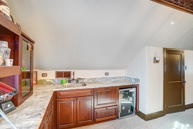 bathroom featuring sink, vaulted ceiling, and beverage cooler