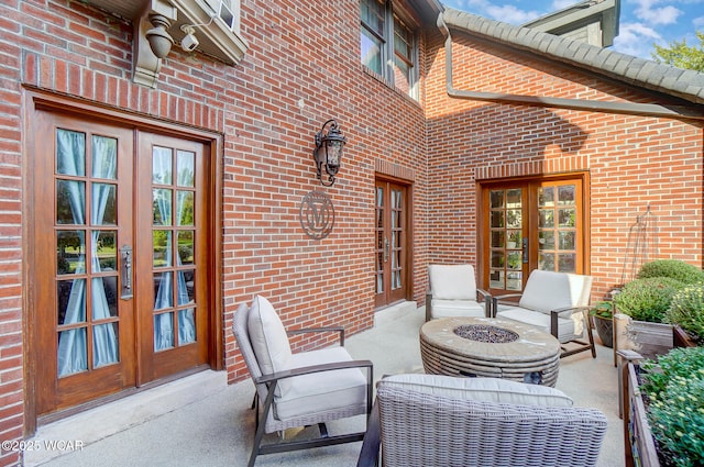 view of patio / terrace featuring a fire pit and french doors