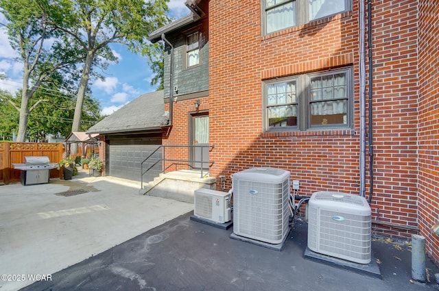 view of side of home with central AC unit