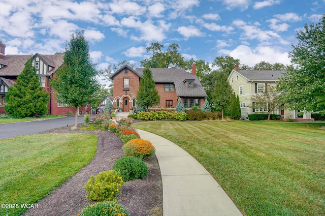 english style home with a front lawn