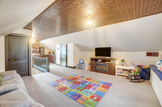 bedroom with vaulted ceiling and carpet floors