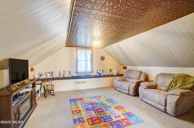 recreation room featuring lofted ceiling and carpet