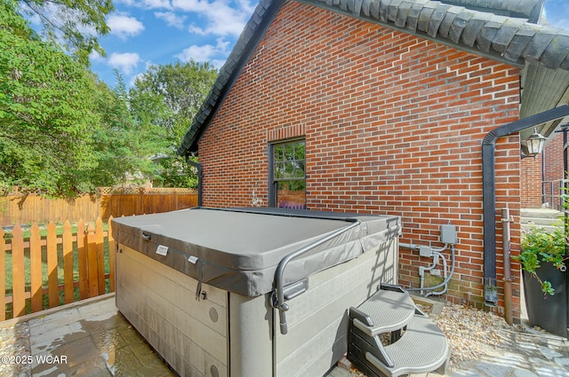 view of home's exterior with a hot tub