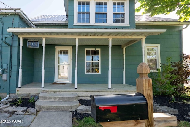 503 N Main St, Bluffton, OH 45817 - property entrance with covered porch and a metal roof