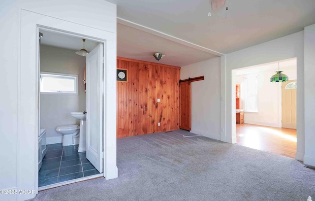 503 N Main St, Bluffton, OH 45817 - carpeted spare room with a barn door and wooden walls