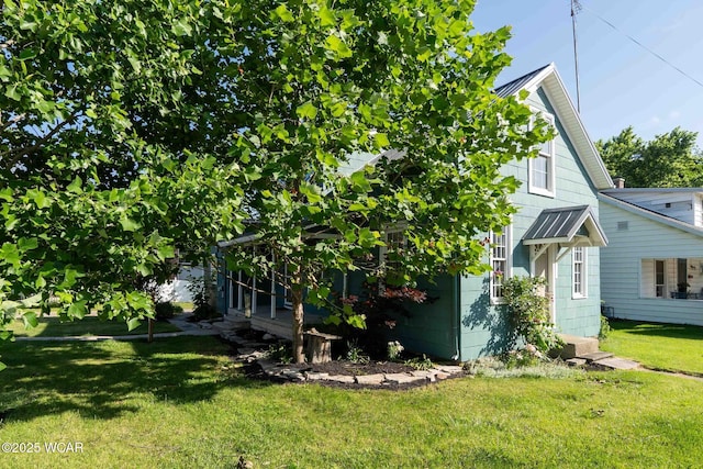503 N Main St, Bluffton, OH 45817 - view of front facade featuring a front yard, a metal roof, and a standing seam roof
