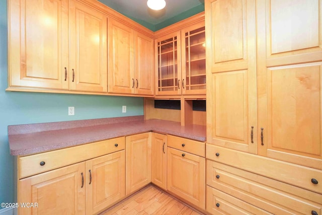 503 N Main St, Bluffton, OH 45817 - kitchen with light brown cabinetry, glass insert cabinets, and light wood-style floors