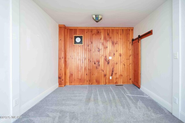 503 N Main St, Bluffton, OH 45817 - carpeted empty room with wood walls and a barn door