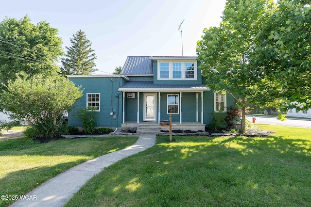 503 N Main St, Bluffton, OH 45817 - view of front facade with covered porch, a front lawn, and a metal roof
