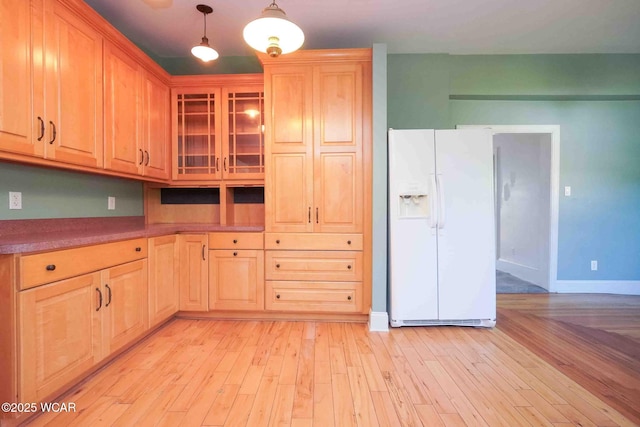 503 N Main St, Bluffton, OH 45817 - kitchen with white refrigerator with ice dispenser, glass insert cabinets, light wood-style floors, light brown cabinets, and hanging light fixtures