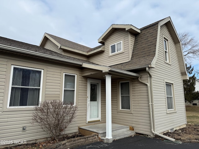 view of front of property featuring roof with shingles and a gambrel roof