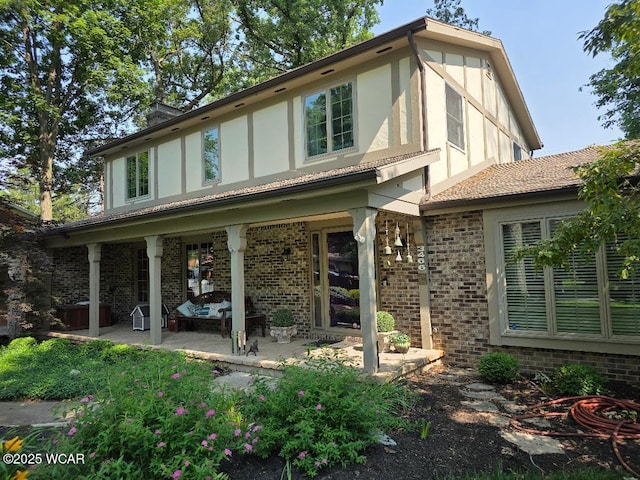 3466 London Dr, Lima, OH 45805 - tudor-style house featuring brick siding, stucco siding, and a patio