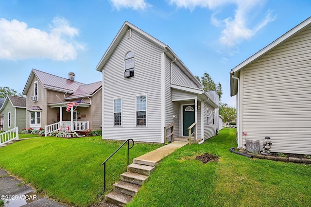 605 Hendricks Ave, Saint Marys, OH 45885 - traditional-style home featuring a front yard, entry steps, and a porch