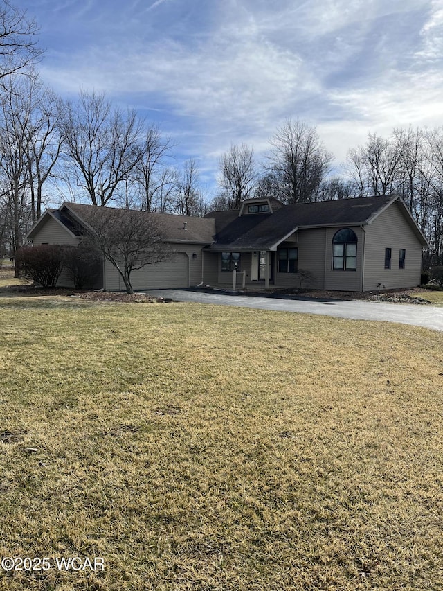 ranch-style home with a garage and a front yard