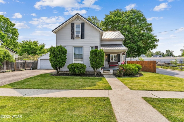 408 Vine St, Kenton, OH 43326 - traditional home featuring covered porch, a metal roof, and a detached garage
