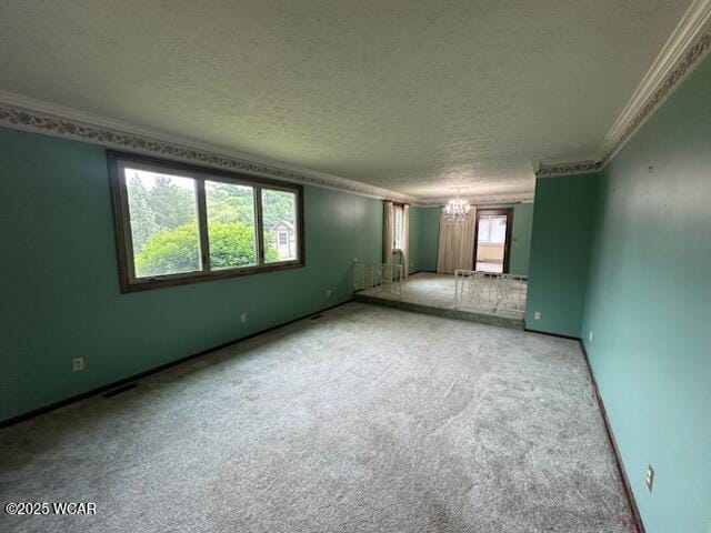 1317 Timberlane Dr, Lima, OH 45805 - empty room featuring a chandelier, crown molding, a textured ceiling, and carpet
