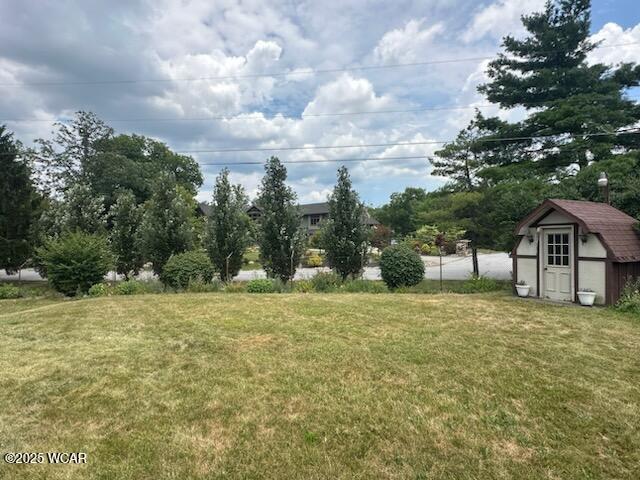 1317 Timberlane Dr, Lima, OH 45805 - view of green lawn with a storage shed