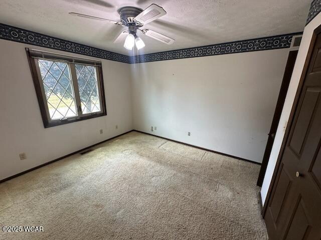 1317 Timberlane Dr, Lima, OH 45805 - empty room with light carpet, a ceiling fan, and a textured ceiling