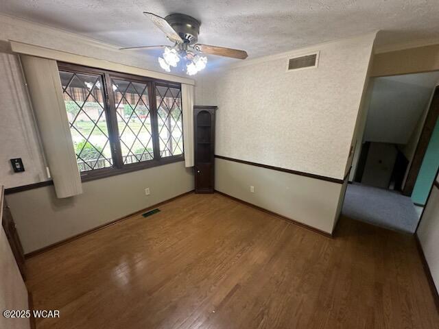1317 Timberlane Dr, Lima, OH 45805 - unfurnished room with ceiling fan, wood finished floors, a textured ceiling, and ornamental molding