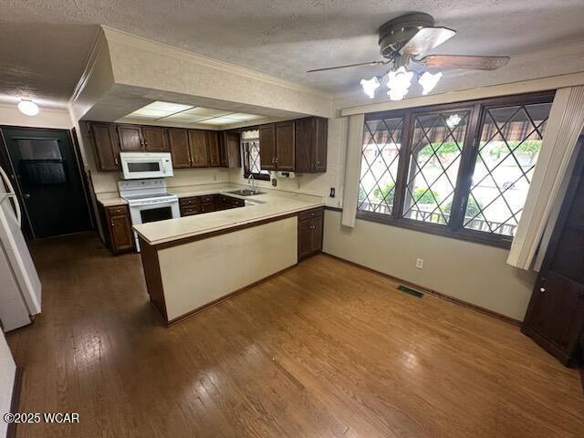 1317 Timberlane Dr, Lima, OH 45805 - kitchen featuring white appliances, a peninsula, ceiling fan, a textured ceiling, and dark brown cabinets