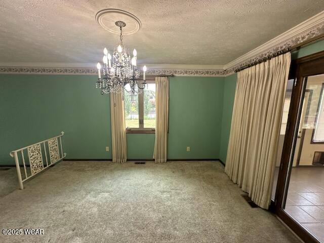 1317 Timberlane Dr, Lima, OH 45805 - unfurnished room with a textured ceiling, a chandelier, ornamental molding, and carpet floors