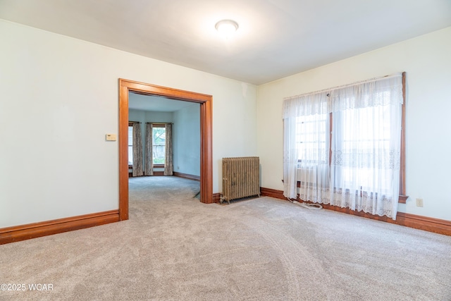 607 W Ash St, Piqua, OH 45356 - spare room featuring radiator heating unit, carpet, and baseboards
