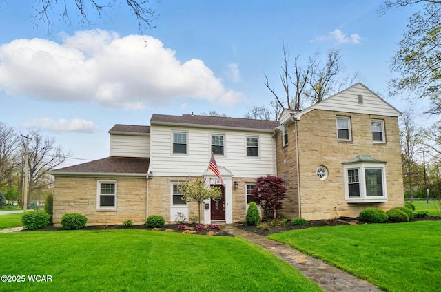 traditional home featuring stone siding and a front lawn