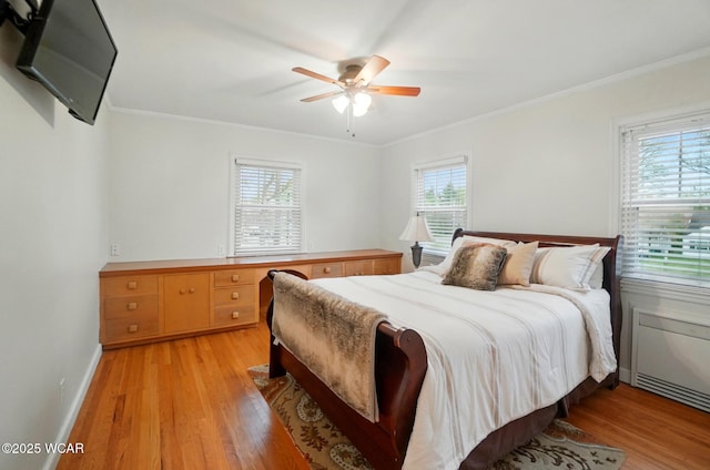 bedroom with baseboards, ornamental molding, light wood-type flooring, and ceiling fan