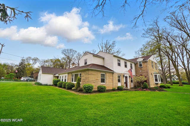 view of side of home featuring a lawn and stone siding