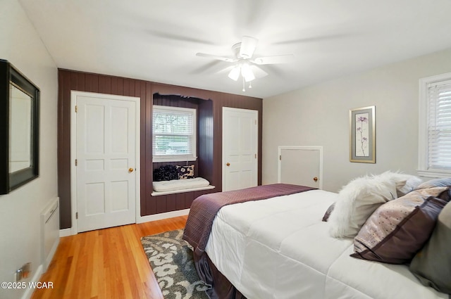 bedroom with a ceiling fan and light wood-type flooring