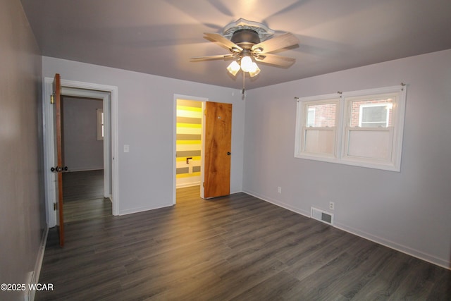 unfurnished bedroom featuring dark wood-type flooring and ceiling fan