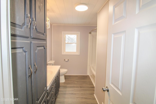 full bathroom featuring vanity, toilet, shower / washtub combination, and hardwood / wood-style floors