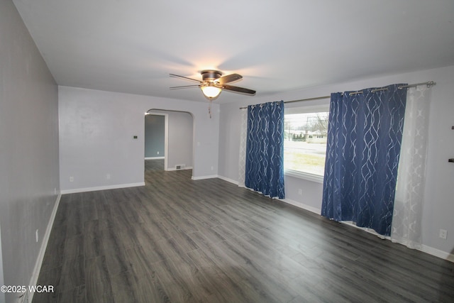 unfurnished room featuring dark hardwood / wood-style flooring and ceiling fan