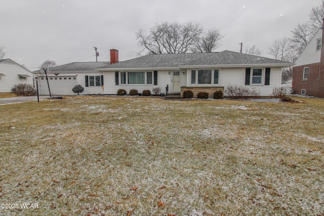 single story home featuring a garage and a front lawn