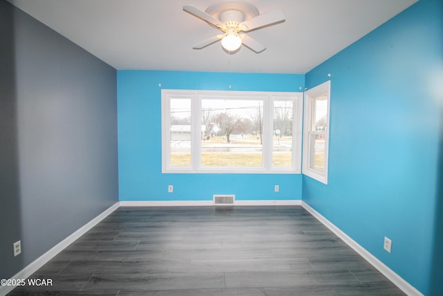 empty room with dark wood-type flooring and ceiling fan